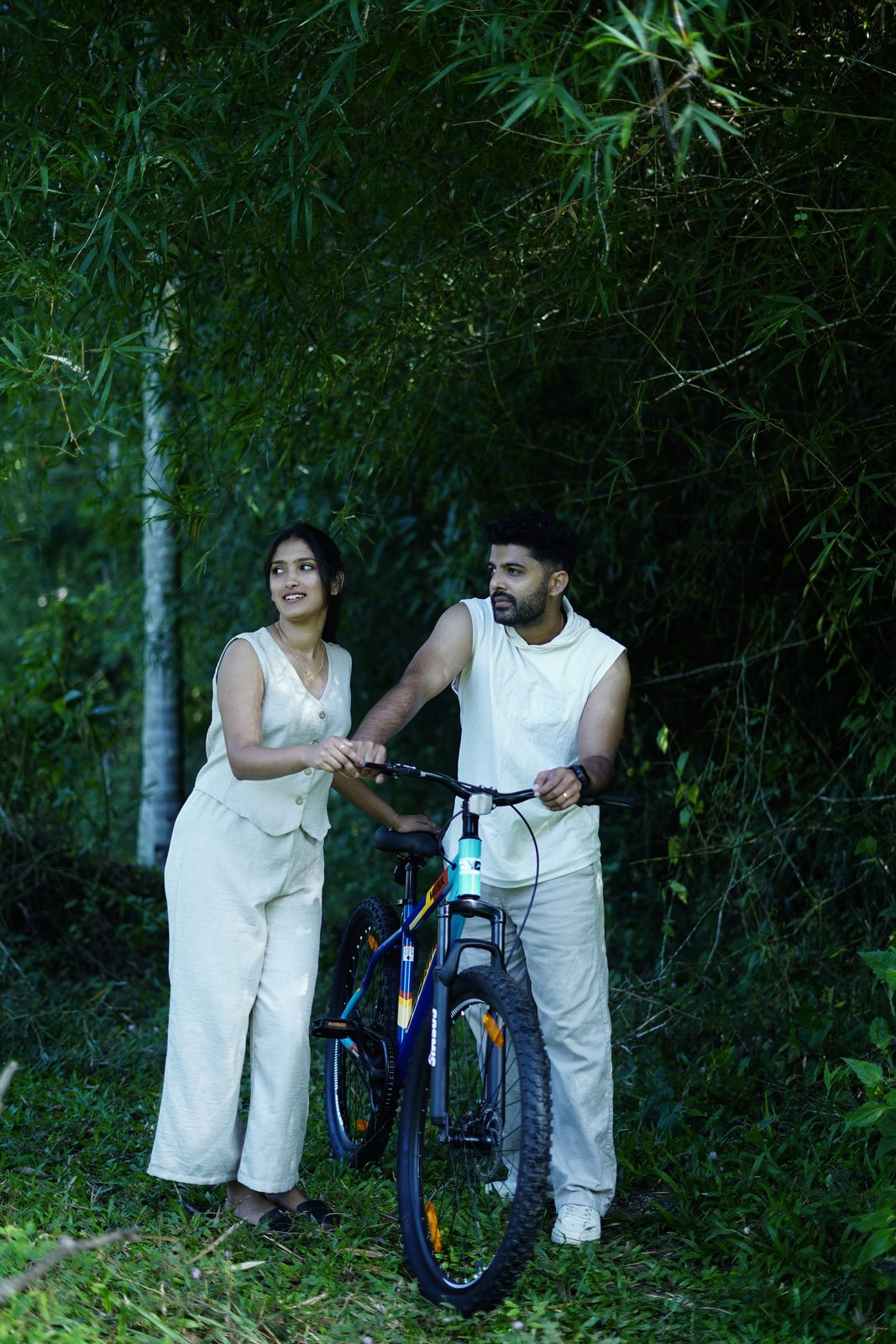 A couple with a mountain bike among the bamboo